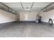 Spacious garage with epoxy flooring, overhead racks, and ample storage space at 11408 Newton Commons Dr # 104, Las Vegas, NV 89135