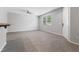 Open concept living room with bright windows and neutral paint at 11408 Newton Commons Dr # 104, Las Vegas, NV 89135