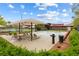 Pool area with shaded seating, lounge chairs, and lush landscaping at 11408 Newton Commons Dr # 104, Las Vegas, NV 89135