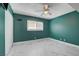 This bedroom is painted teal and includes a ceiling fan, closet and large window at , Las Vegas, NV 89145