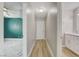 Hallway offers access to bathroom and bedroom showcasing ceiling fan and marble-look floors at , Las Vegas, NV 89145