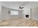 Inviting living room with brick fireplace, sleek ceiling fan, and ample natural light at , Las Vegas, NV 89145
