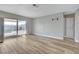 Bright, open living area with sliding glass door to the backyard and modern wood flooring at , Las Vegas, NV 89145