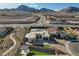Aerial view of a modern home with a pool, cabana, turf yard, desert landscaping, and mountain views at 12199 Canyon Sunset St, Las Vegas, NV 89138