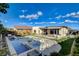 Expansive backyard with a pool, spa, playground, outdoor dining, grill, and turf, ideal for outdoor entertaining at 12199 Canyon Sunset St, Las Vegas, NV 89138