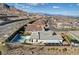 Aerial view of a home with a pool, playground, covered patio, and desert landscaping in a suburban community at 12199 Canyon Sunset St, Las Vegas, NV 89138