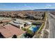 Expansive aerial view of a modern home with pool, playground, and desert landscaping in a suburban community at 12199 Canyon Sunset St, Las Vegas, NV 89138