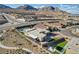 Aerial view of a modern home with a pool, outdoor seating area, turf yard, and mountain views at 12199 Canyon Sunset St, Las Vegas, NV 89138