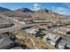 An aerial view of a neighborhood highlighting the homes and the surrounding desert landscape at 12199 Canyon Sunset St, Las Vegas, NV 89138