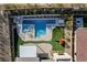 Aerial of a modern backyard featuring a pool, spa, playground, turf, desert landscaping, and seating at 12199 Canyon Sunset St, Las Vegas, NV 89138