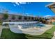 Spacious backyard with a pool, spa, lounge area, and lush greenery, creating a private retreat for relaxation at 12199 Canyon Sunset St, Las Vegas, NV 89138
