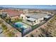 Aerial of a modern backyard featuring a pool, spa, playground, covered patio, and artificial turf at 12199 Canyon Sunset St, Las Vegas, NV 89138