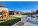 Stunning backyard featuring a pool, outdoor seating, a playset, and immaculate landscaping at 12199 Canyon Sunset St, Las Vegas, NV 89138