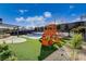 Lush backyard with a pool, a playset, and an outdoor kitchen making it perfect for Gathering gatherings and entertainment at 12199 Canyon Sunset St, Las Vegas, NV 89138