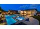 Inviting backyard with a pool, hot tub, patio, outdoor dining area and well-maintained landscaping at 12199 Canyon Sunset St, Las Vegas, NV 89138