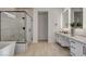 Elegant bathroom with freestanding tub, glass enclosed shower, and double vanity with modern fixtures at 12199 Canyon Sunset St, Las Vegas, NV 89138
