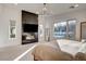 Modern bedroom boasts a sleek fireplace, large windows overlooking pool, and minimalist design at 12199 Canyon Sunset St, Las Vegas, NV 89138