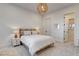 Bright bedroom featuring a queen bed, stylish lighting, and ensuite bathroom access at 12199 Canyon Sunset St, Las Vegas, NV 89138