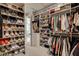 Spacious walk-in closet with extensive shelving, hanging racks, and storage for shoes and clothing at 12199 Canyon Sunset St, Las Vegas, NV 89138