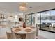 Bright dining room with access to the patio, featuring a round table and an open-concept layout at 12199 Canyon Sunset St, Las Vegas, NV 89138