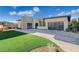Modern home featuring a brick driveway, turf lawn and two-car garage with translucent glass doors at 12199 Canyon Sunset St, Las Vegas, NV 89138