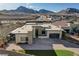 Modern home exterior with stone accents, a paved driveway, and three-car garage at 12199 Canyon Sunset St, Las Vegas, NV 89138