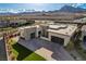 View of a modern home featuring three garage doors, a paved driveway, and landscaping at 12199 Canyon Sunset St, Las Vegas, NV 89138