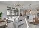 Bright and airy living room featuring a modern chandelier, sleek flooring, and open-concept design at 12199 Canyon Sunset St, Las Vegas, NV 89138