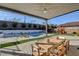Expansive backyard with an outdoor kitchen and dining area, pool, and playground, perfect for relaxing and entertaining at 12199 Canyon Sunset St, Las Vegas, NV 89138