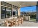 Covered outdoor patio featuring an elegant dining set, built-in grill, and picturesque backyard views at 12199 Canyon Sunset St, Las Vegas, NV 89138