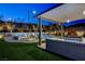 Outdoor kitchen with stainless steel grill overlooking the pool and lush backyard, perfect for entertaining guests at 12199 Canyon Sunset St, Las Vegas, NV 89138