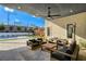 Comfortable outdoor patio with cushioned seating, ceiling fan, and backyard views with pool and playground at 12199 Canyon Sunset St, Las Vegas, NV 89138