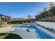Beautiful pool area with contemporary design, lush landscaping, and ample space for outdoor relaxation and entertaining at 12199 Canyon Sunset St, Las Vegas, NV 89138
