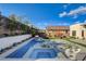 Stunning backyard oasis with a pool, spa, and lounge area surrounded by lush landscaping for ultimate relaxation at 12199 Canyon Sunset St, Las Vegas, NV 89138