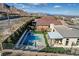 View of a backyard including a pool, patio, play area, and covered outdoor kitchen at 12199 Canyon Sunset St, Las Vegas, NV 89138