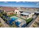 Aerial view of a home's backyard featuring a pool, outdoor dining, and playground at 12199 Canyon Sunset St, Las Vegas, NV 89138