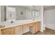 Bathroom featuring double sinks, wood-look flooring, and ample counter space at 1405 Sycamore Spring Ct, Las Vegas, NV 89128