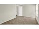 Sunlit bedroom with soft carpeting and entry to other rooms at 1405 Sycamore Spring Ct, Las Vegas, NV 89128