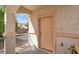 Front porch with neutral-colored door, decorative pillars, and wrought iron railing for a secure feel at 1405 Sycamore Spring Ct, Las Vegas, NV 89128