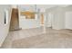 Open floor plan with staircase, kitchen and living area with combined plush carpet and tile flooring at 1405 Sycamore Spring Ct, Las Vegas, NV 89128
