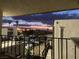 Balcony view of parking lot, palm trees, mountains, and colorful sunset sky at 1405 Vegas Valley Dr # 236, Las Vegas, NV 89169