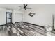 Spacious bedroom featuring unique flooring, a ceiling fan, and access to an ensuite bathroom and walk-in closet at 1405 Vegas Valley Dr # 236, Las Vegas, NV 89169