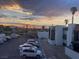 View from condo exterior over the parking lot at sunset with mountains in the background at 1405 Vegas Valley Dr # 236, Las Vegas, NV 89169