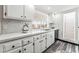 Modern kitchen with white cabinets, stylish countertops, stainless steel sink, and sun-filled window view at 1405 Vegas Valley Dr # 236, Las Vegas, NV 89169