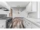 Modern kitchen featuring white cabinets, stainless appliances, quartz countertops and weathered wood-style flooring at 1405 Vegas Valley Dr # 236, Las Vegas, NV 89169