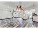 Inviting living room and kitchen with open space, white cabinetry, and striking weathered wood-style flooring at 1405 Vegas Valley Dr # 236, Las Vegas, NV 89169