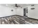 Bright living room featuring contemporary ceiling fan, neutral walls and striking weathered wood-style flooring at 1405 Vegas Valley Dr # 236, Las Vegas, NV 89169