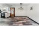Open living room featuring weathered wood flooring, and unique light fixtures at 1405 Vegas Valley Dr # 236, Las Vegas, NV 89169