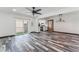 Bright living room with sliding door access to balcony, contemporary ceiling fan and rustic weathered wood flooring at 1405 Vegas Valley Dr # 236, Las Vegas, NV 89169