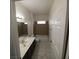 Bathroom featuring neutral tile flooring, a single sink vanity, and a shower-tub combo at 1621 Sandecker Ct # 104, Las Vegas, NV 89146